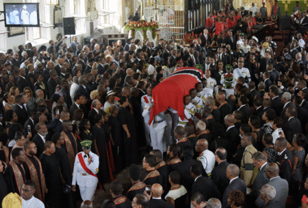 Members of the Trinidad and Tobago Defence Force bear the coffin adorned with the national flag of former prime minister Patrick A.M. Manning. Photo: Nation News